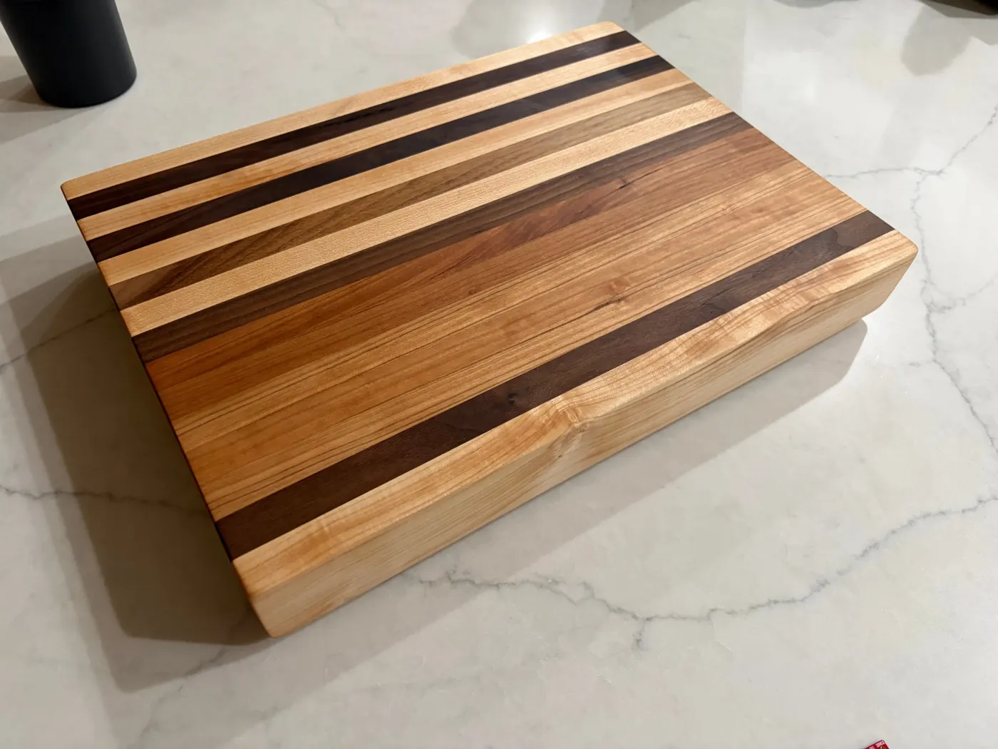 The finished striped cutting board on a white counter